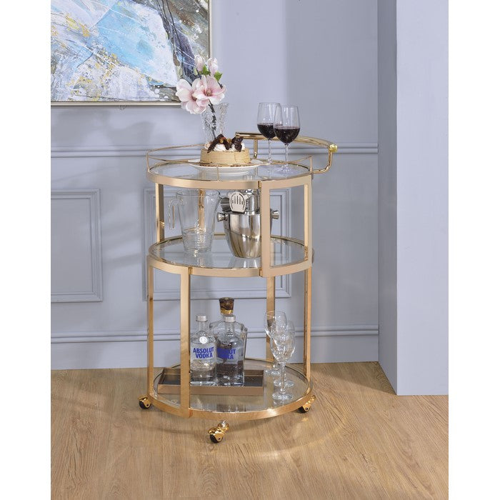 Three Tiered Metal Serving Cart with Glass Inserted Shelves and Curved Side Handle, Gold